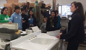 Robin Elliott, Philanthropy Coordinator at ReUse, leading a walking tour of the store.